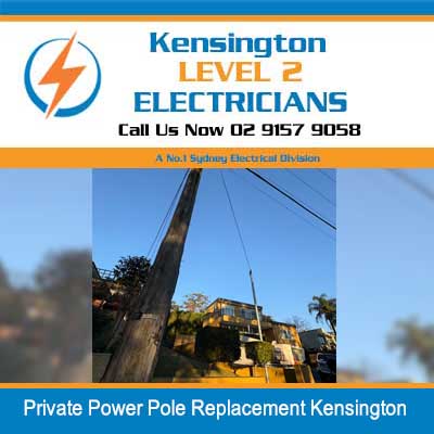 Utility worker in elevated cherry picker replacing private power pole in Kensington